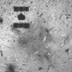 The shadow of Hayabusa2 can be seen on the asteroid’s surface, along with the new dark smudge at the touchdown site.
